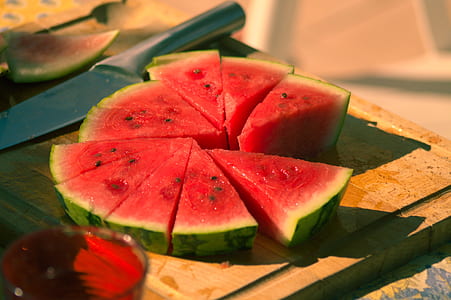 selective focus photo of sliced watermelon on chopping board beside knife thumbnail