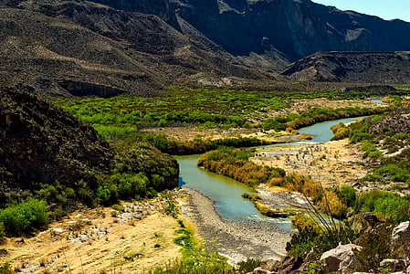 birds eye photography of mountain near body of water thumbnail