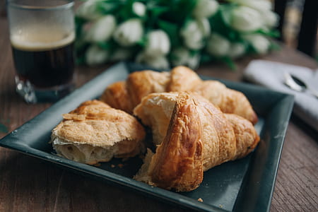 baked pastry on black plate near flowers thumbnail