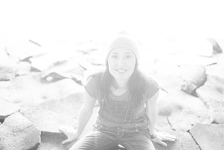 woman sitting on rock while smiling thumbnail