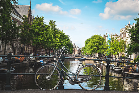 Bicycle by a canal in Amsterdam, Holland thumbnail