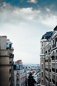aerial photography of brown and white buildings under white and blue sky at daytime thumbnail