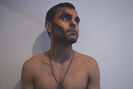 man wearing necklace looking right side thumbnail
