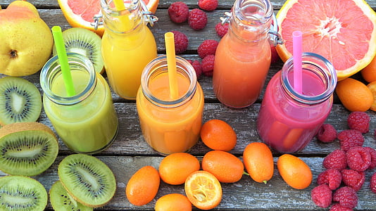 five clear glass containers filled with assorted fruit juices thumbnail