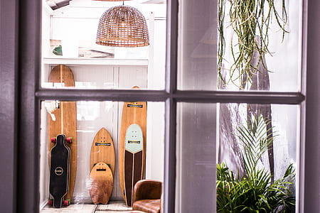 black longboard and bodyboards inside house thumbnail