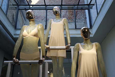 three woman mannequins on pole thumbnail