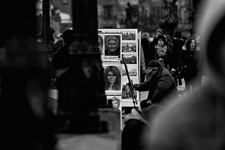 man painting on street in grayscale photography thumbnail