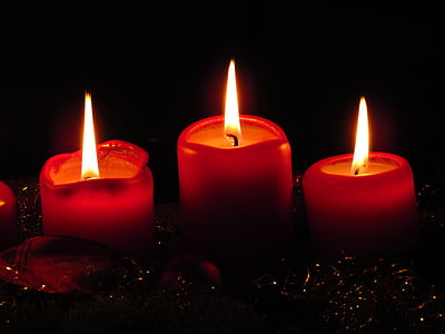 three red lighted votive candles thumbnail