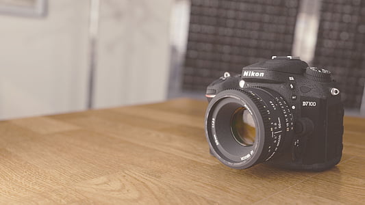 selective focus photography black Nikon DSLR camera on table thumbnail