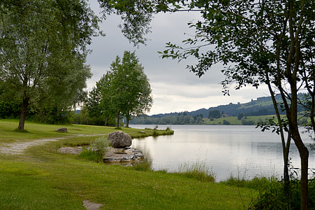 wide angle photo of body of water under cloudy sky thumbnail