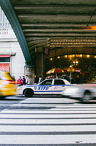 NYPD Ford Crown Victoria near near taxi under grey bridge thumbnail