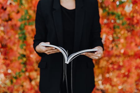 Girl with the Grafconf book on the background of colourful leaves thumbnail