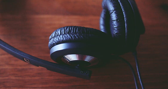 black corded headphones on brown surface thumbnail