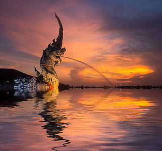 photo of dragon statue beside water thumbnail