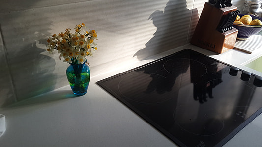 black induction stove on top of white cubicle thumbnail