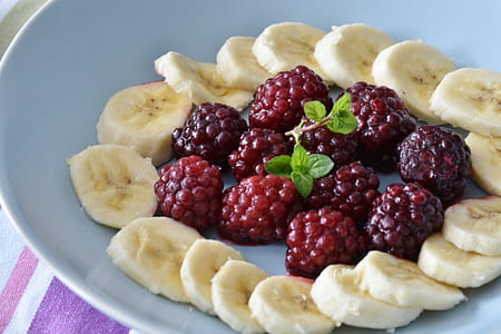 bunch of grapes and sliced banana serve on white ceramic plate thumbnail