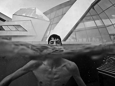 grayscale photography of man on water thumbnail