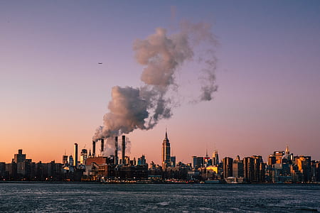 white smoke on building near body of water thumbnail