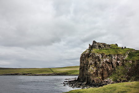 brown cliff near body of water thumbnail