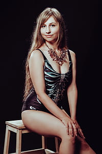 woman sitting on brown wooden stool thumbnail