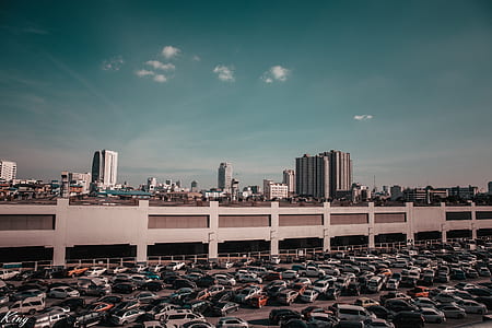 cars parked near gray concrete building thumbnail
