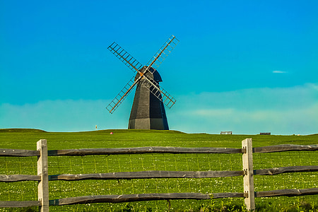 windmill surrounded by green grass thumbnail