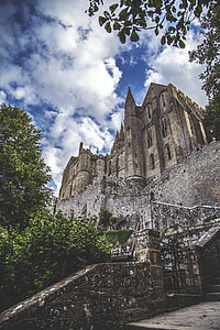 brown castle under blue sky and white clouds thumbnail
