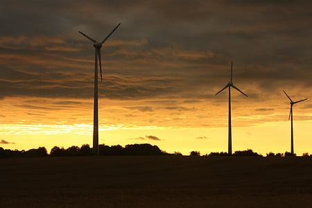 three windmills under yellow cloudy sky thumbnail