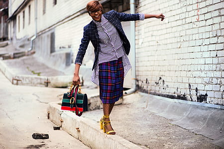 Person Wearing Blue and Black Blazer Holding Bag thumbnail