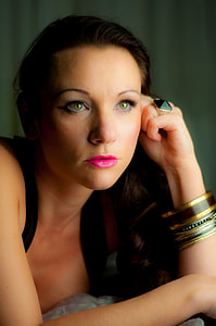 woman in black top wearing gold bangles with pink lipstick closeup photography thumbnail