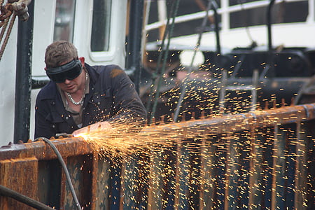man wearing black jacket using power tool thumbnail