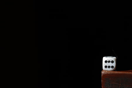 white and black dice on brown wooden surface thumbnail