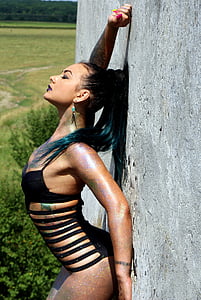 woman in black monokini leaning on wall during daytime thumbnail