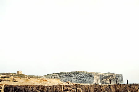 people on mountain under blue sky thumbnail