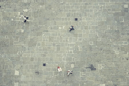 aerial photography of people walking on gray concrete flooring thumbnail