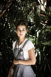 woman standing beside green leaf plants during daytime thumbnail