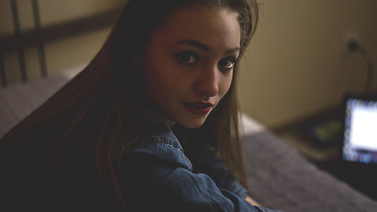 woman on gray bed selective focus photography thumbnail