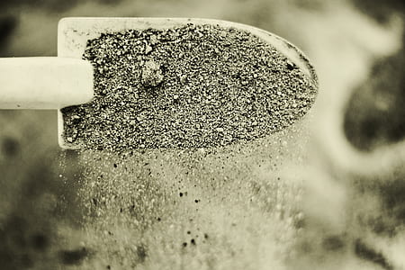 shovel with sand in close up photography thumbnail