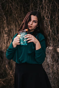 selective focus of woman holding string light jar thumbnail