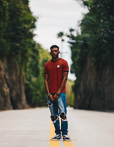 man standing on grey concrete road thumbnail