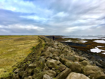 person standing on sea shore thumbnail
