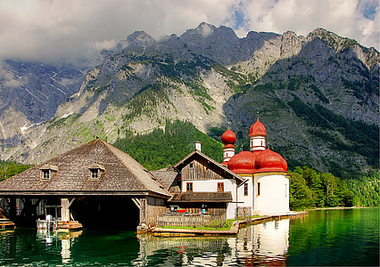 red and white mosque near body of water thumbnail
