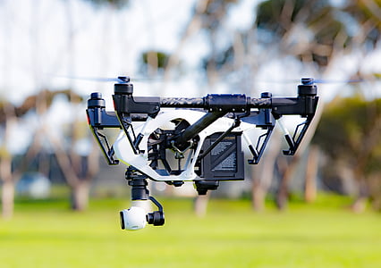 shallow focus photography of black and white quadcopter drone thumbnail