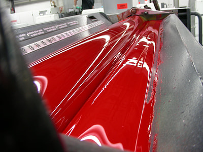 close up photo of red liquid flowing on gray metal surface thumbnail