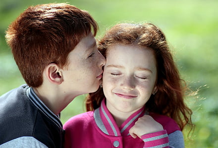 boy kissing girl in shallow focus photography thumbnail