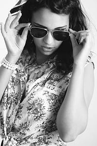 woman in floral top wearing sunglasses thumbnail