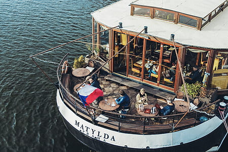 people sitting on bistro chair set in ship thumbnail