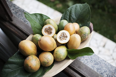 brown and green fruits on brown wooden bowl thumbnail