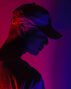 man wearing cap with purple light background thumbnail