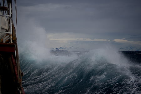 sea waves under gray sky during daytime thumbnail